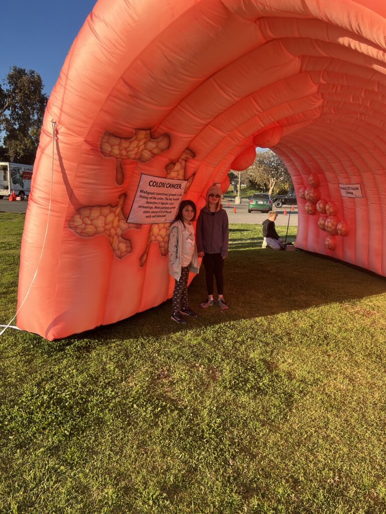 Two People Standing In The Inflatable Colon