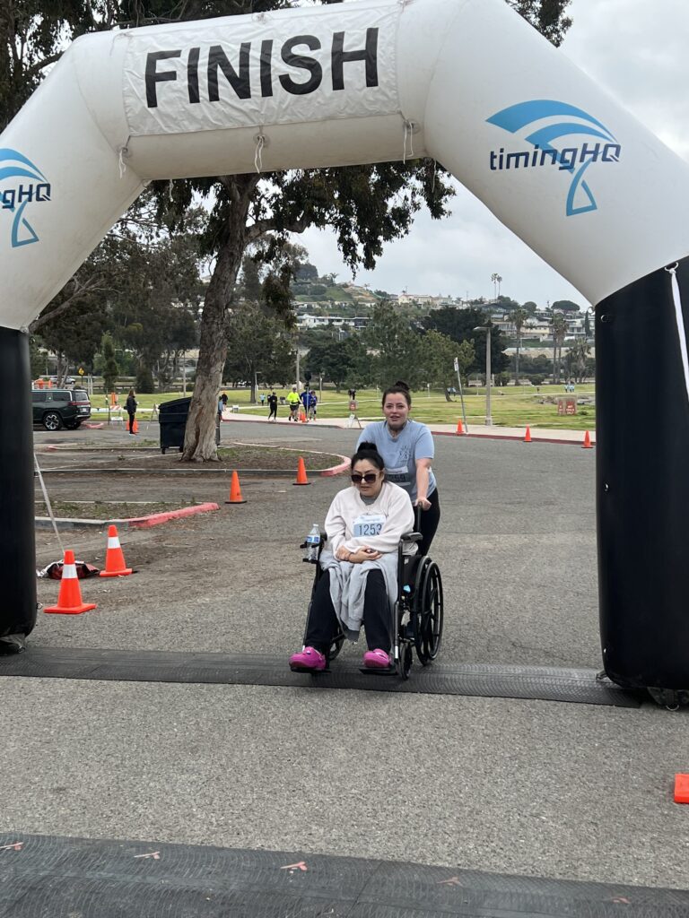 Two Person Effort - Runner and Woman in Wheelchair